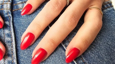 Elegant red manicure at GELuxe Nail Studio, Dapto, New South Wales, AU, showcasing vibrant nail art.
