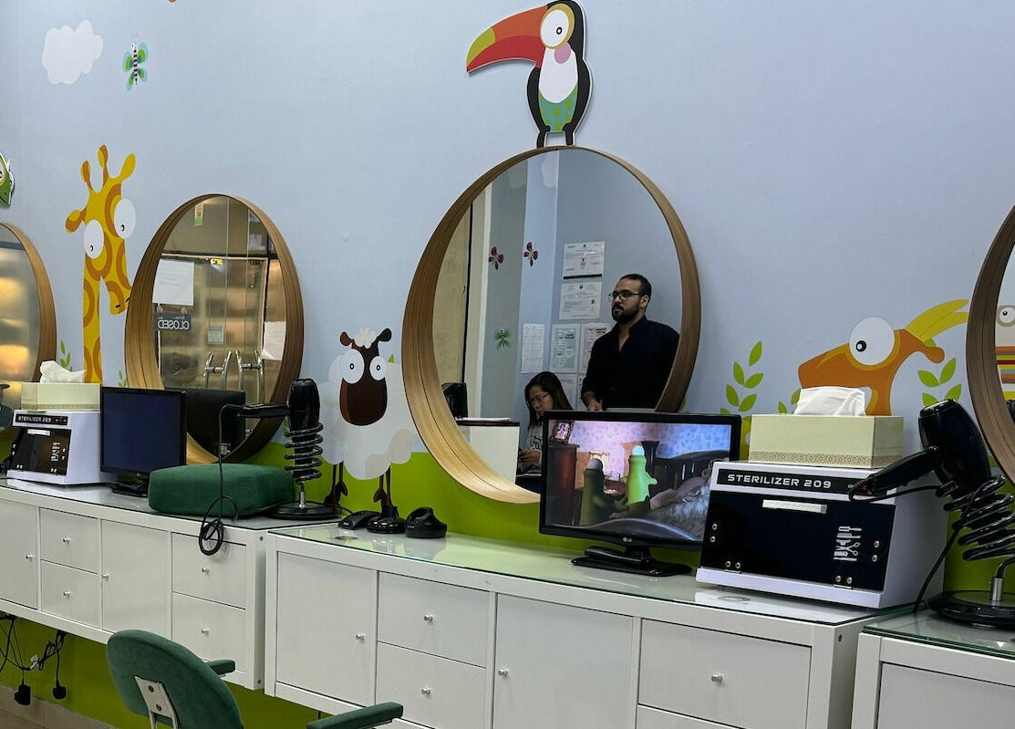 Bright and playful decor at White Sheep Kids Salon in Abu Dhabi, AE with colorful animal designs on the walls.