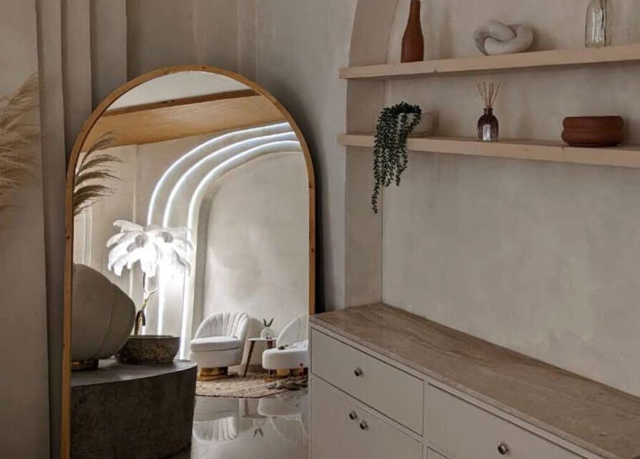 Boho Bliss interior with elegant mirror and decor in Bali, Bali, ID showcasing natural tones and greenery.