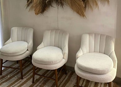Elegant white chairs in Boho Bliss, Bali, Bali, ID invite relaxation and comfort.