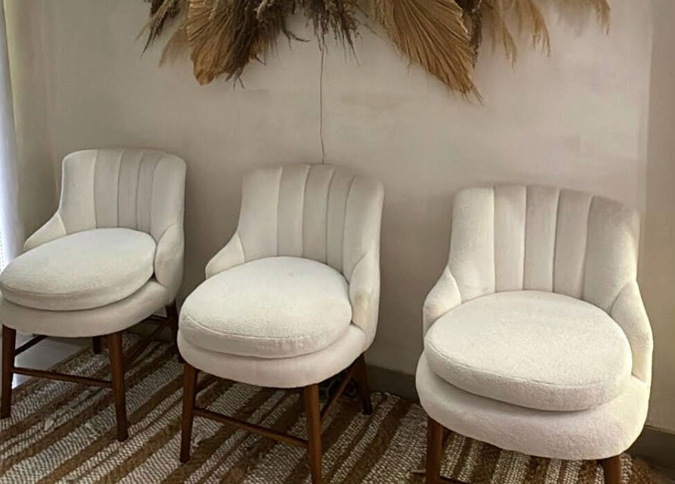 Elegant white chairs in Boho Bliss, Bali, Bali, ID invite relaxation and comfort.