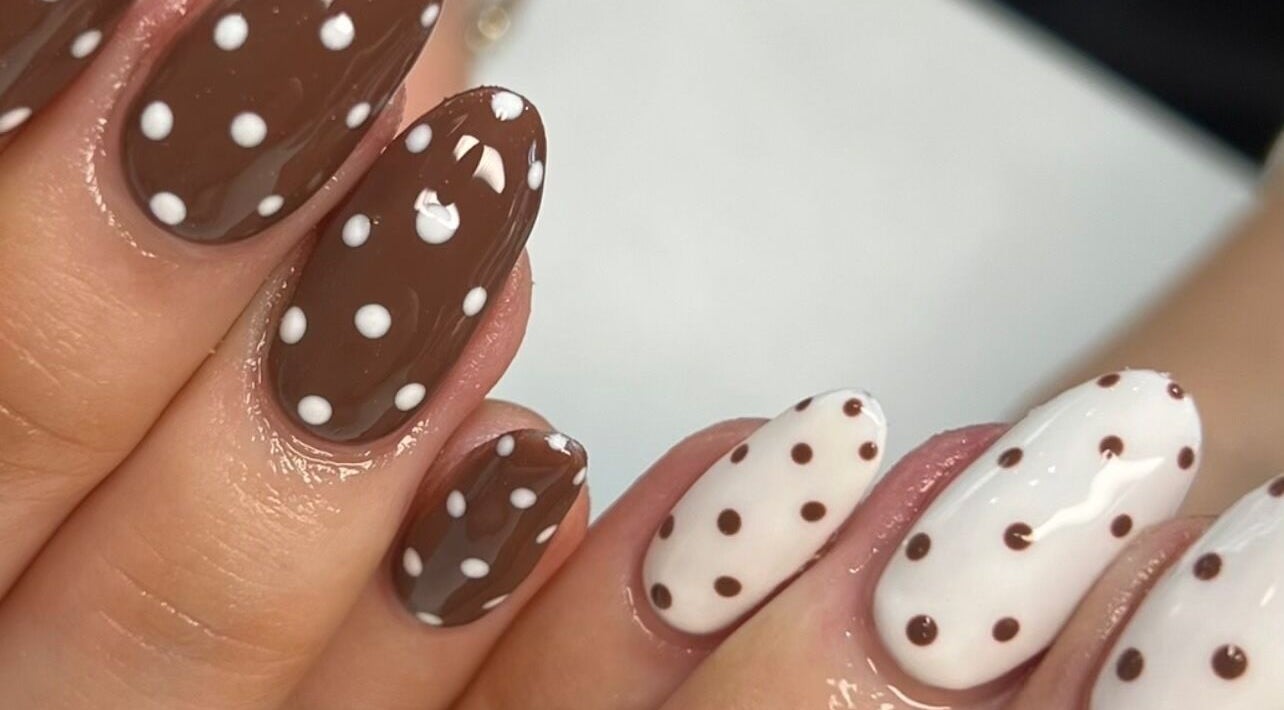 Elegant polka-dot nail art at Nailedit Bymillie, Burnley, England, GB. Perfect for a chic, trendy look.