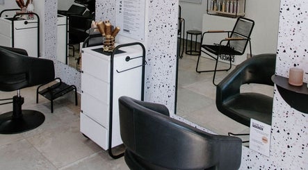 Modern interior of Blow Dry Bar - Garsfontein in Pretoria, Gauteng, ZA featuring sleek black chairs and stylish decor.