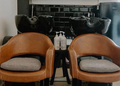 Elegant wash stations at Blow Dry Bar - Garsfontein, Pretoria, Gauteng, ZA, featuring chic brown chairs.
