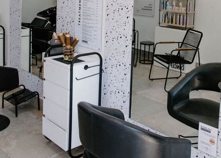 Stylish salon setup at Blow Dry Bar - Silver Lakes, Shere, Gauteng, ZA with sleek black chairs and modern decor.