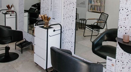 Stylish salon setup at Blow Dry Bar - Silver Lakes, Shere, Gauteng, ZA with sleek black chairs and modern decor.