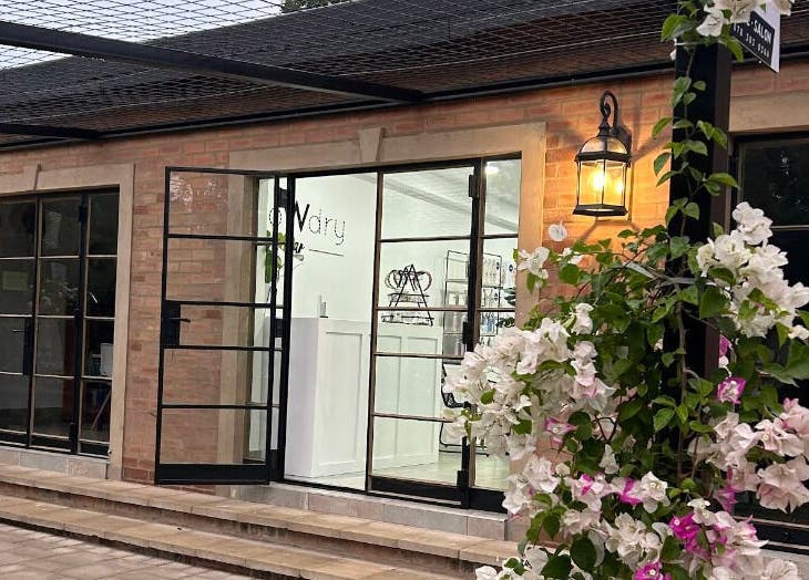 Elegant exterior of Blow Dry Bar - Silver Lakes in Shere, Gauteng, ZA adorned with blooming flowers.
