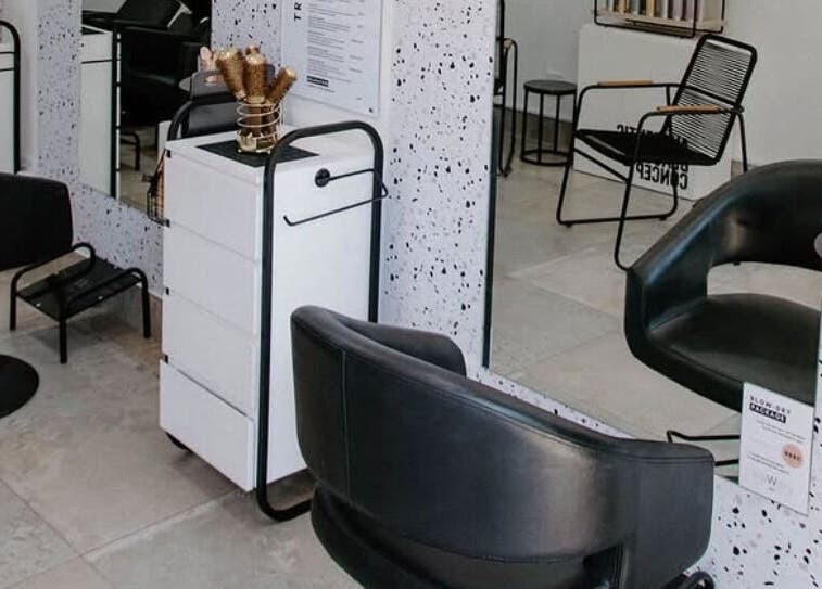 Modern salon interior at Blow Dry Bar - Silver Lakes in Shere, Gauteng, ZA, featuring stylish black chairs.