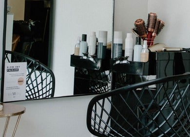 Modern salon station at Blow Dry Bar - Garsfontein, Pretoria, Gauteng, ZA with stylish chair and hair products.