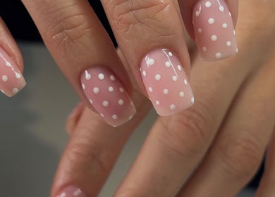 Polka dot nail art at Gel Serenity in Advancetown, Queensland, AU. Perfectly manicured hands display stylish design.