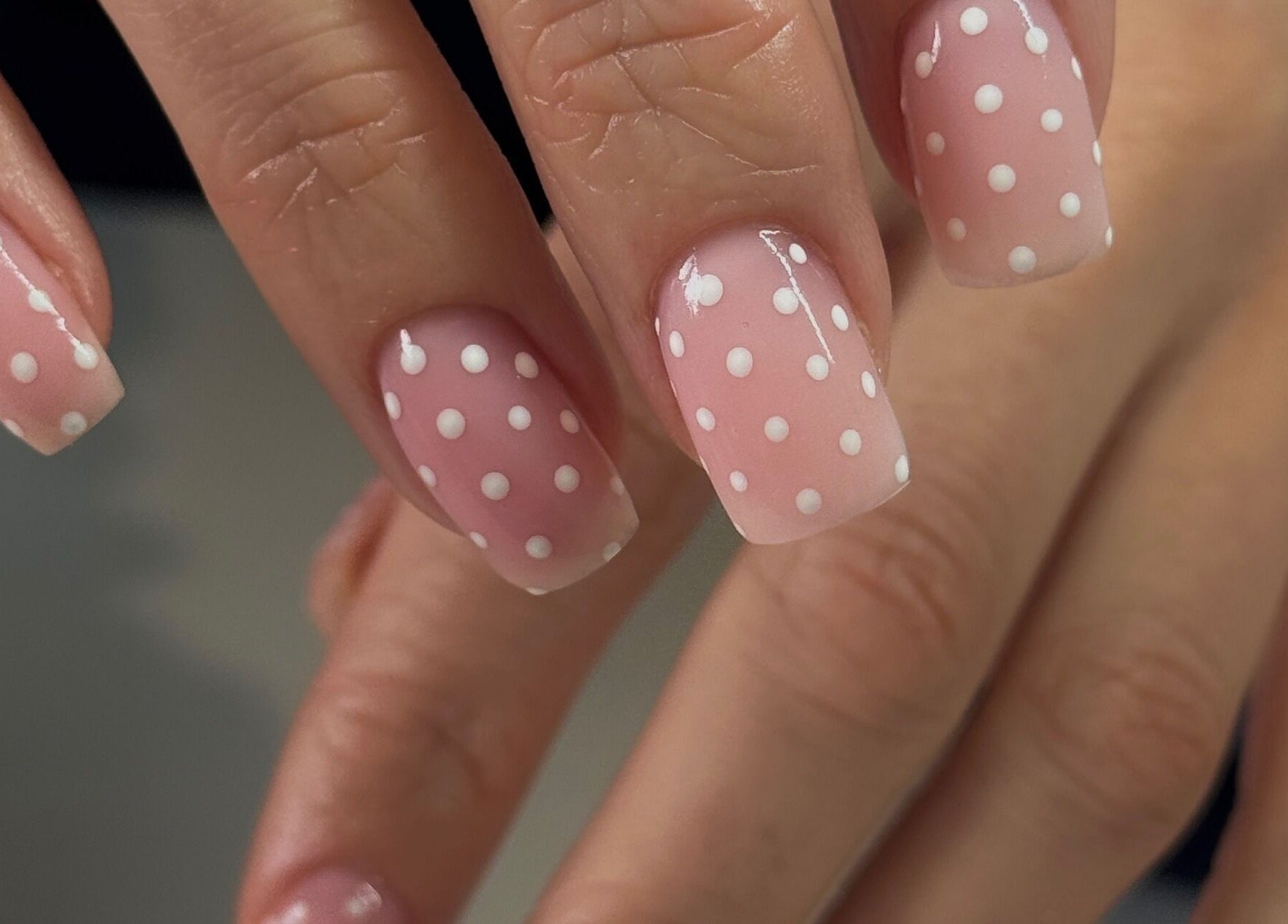 Polka dot nail art at Gel Serenity in Advancetown, Queensland, AU. Perfectly manicured hands display stylish design.