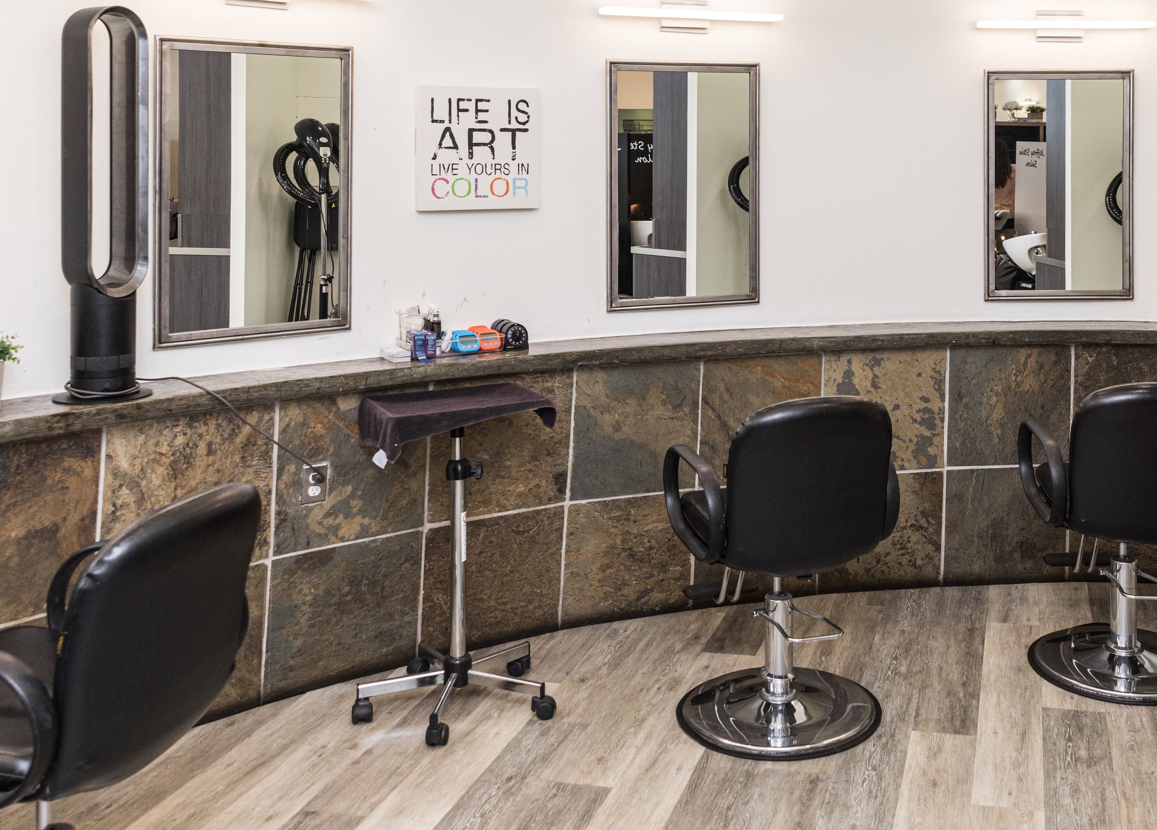 Modern styling chairs at Jeffrey Stein Salon, New York, New York, US, with sleek mirrors and decor.