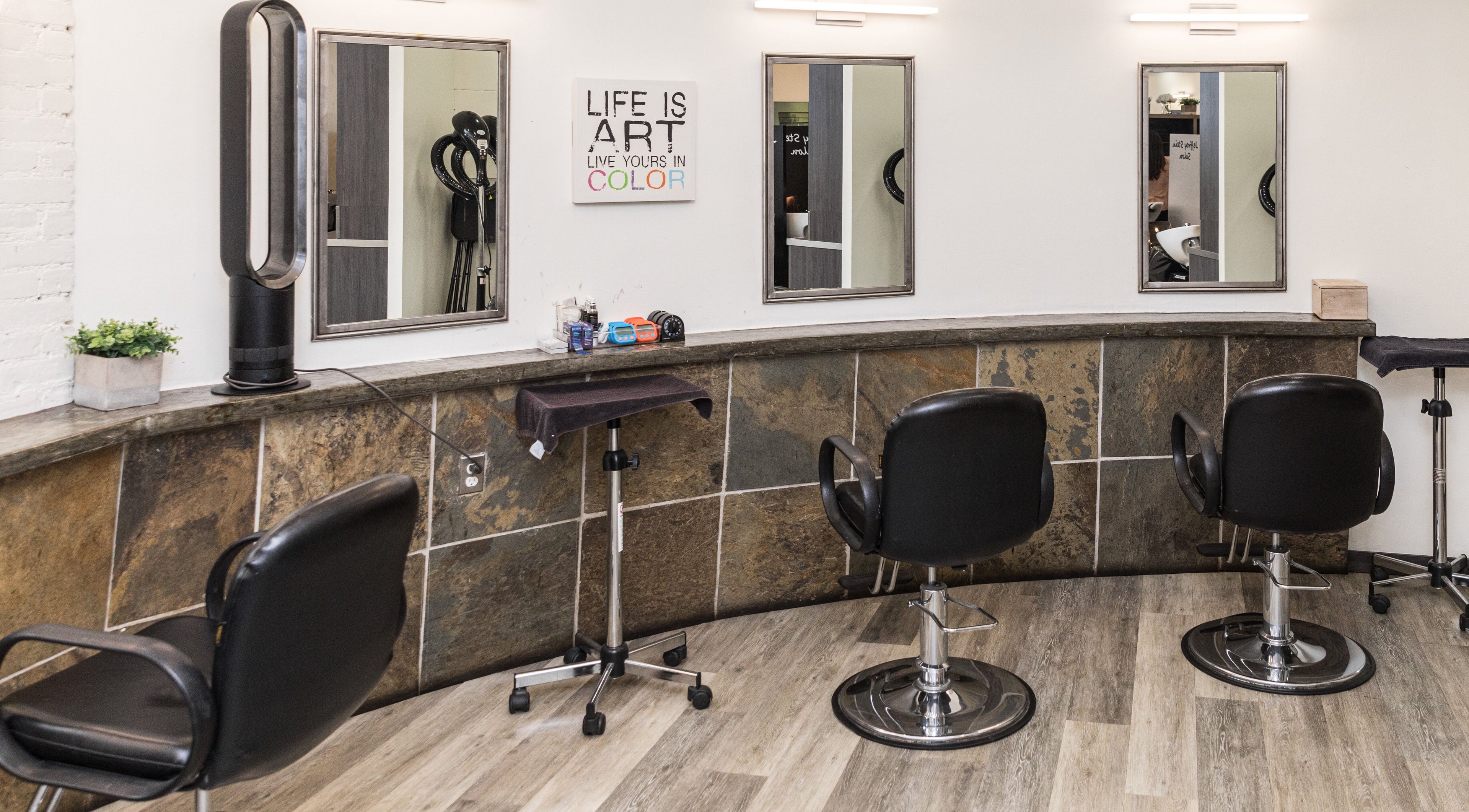 Modern styling chairs at Jeffrey Stein Salon, New York, New York, US, with sleek mirrors and decor.