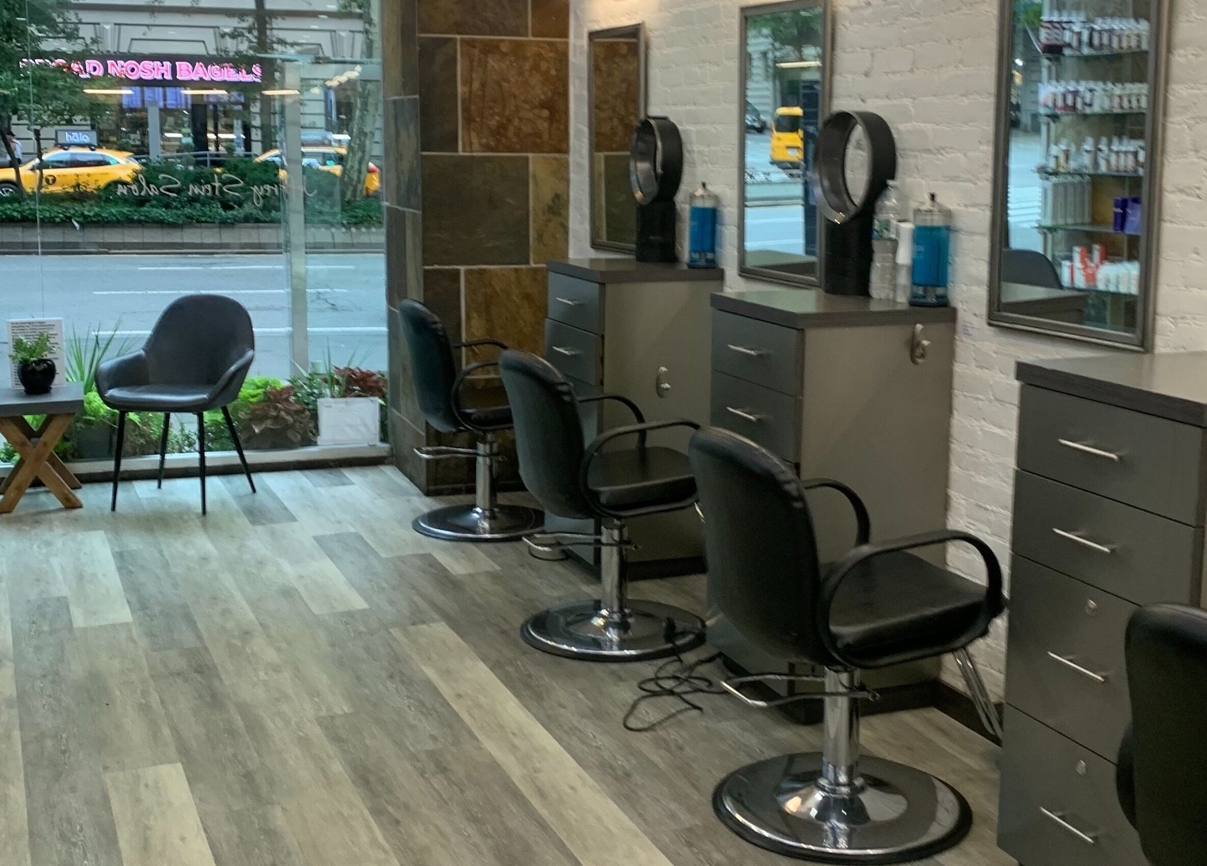 Interior of Jeffrey Stein Salon in New York, New York, US showcasing chic styling stations and urban street view.