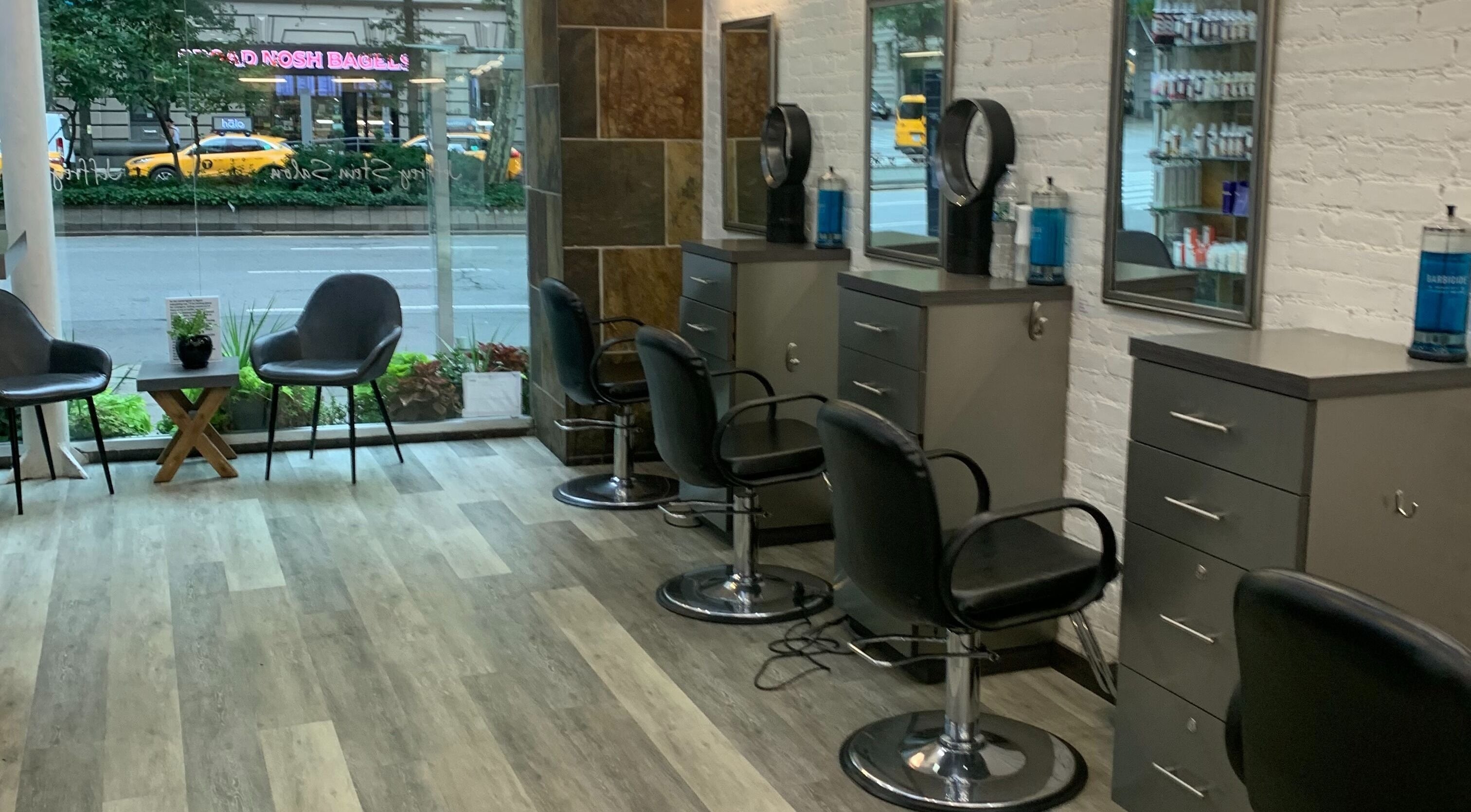 Interior of Jeffrey Stein Salon in New York, New York, US showcasing chic styling stations and urban street view.