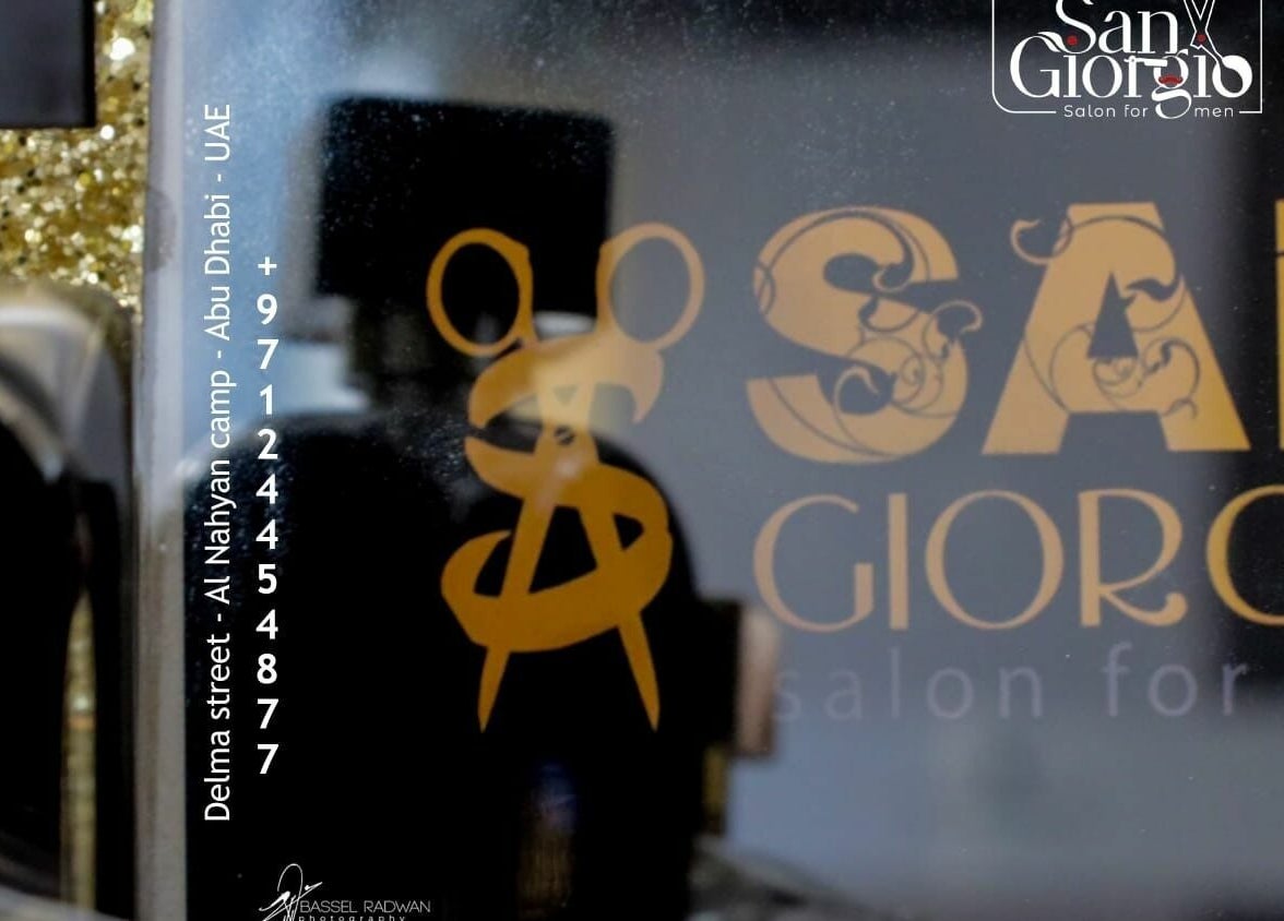 San Giorgio Gents Salon logo and address in Abu Dhabi, AE, showcased with elegant golden design.