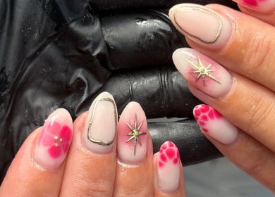 Stylish nail art with gold stars at Beauty by Harriet - Glow Hair Salon, Crownhill, England, GB.