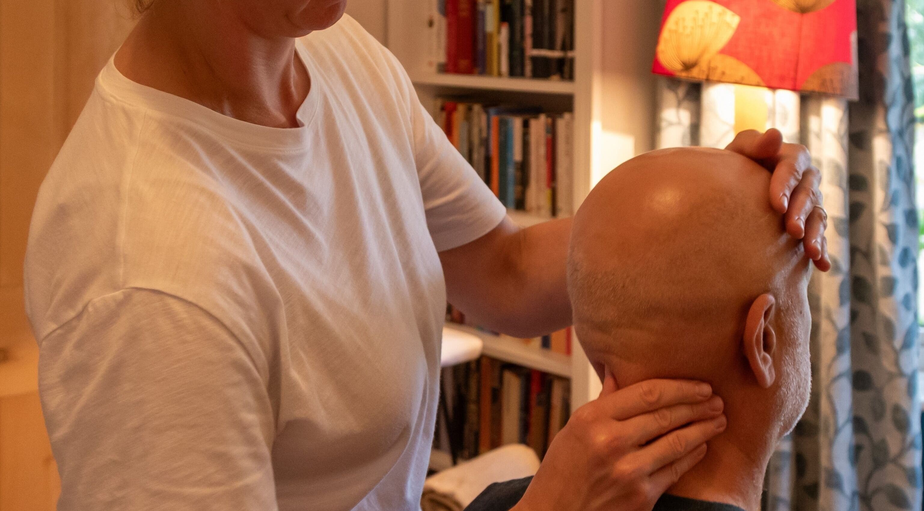 Therapist at Elemental Balancing in Bristol, England, GB providing a relaxing head massage session.