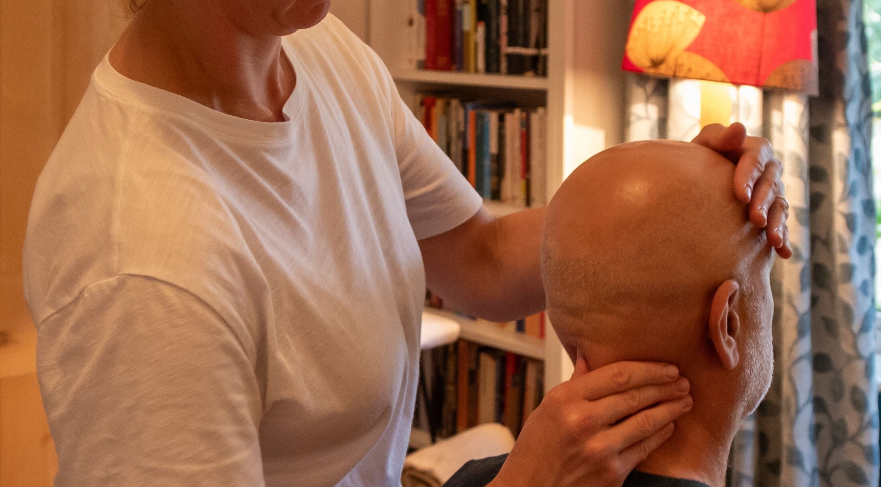 Therapist at Elemental Balancing in Bristol, England, GB providing a relaxing head massage session.