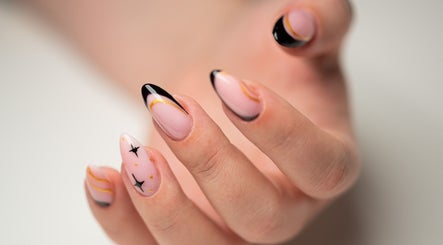 Elegant black and nude nail art with gold accents at Dia Nailed It, Hove, England, GB.