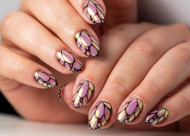 Intricate butterfly nail art at Dia Nailed It, Hove, England, GB showcases elegant design and vibrant colors.