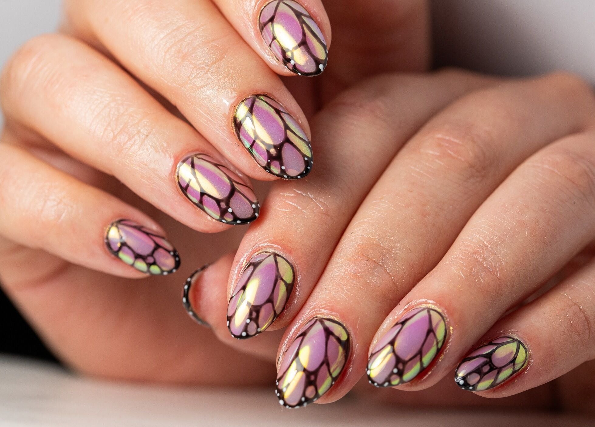 Intricate butterfly nail art at Dia Nailed It, Hove, England, GB showcases elegant design and vibrant colors.