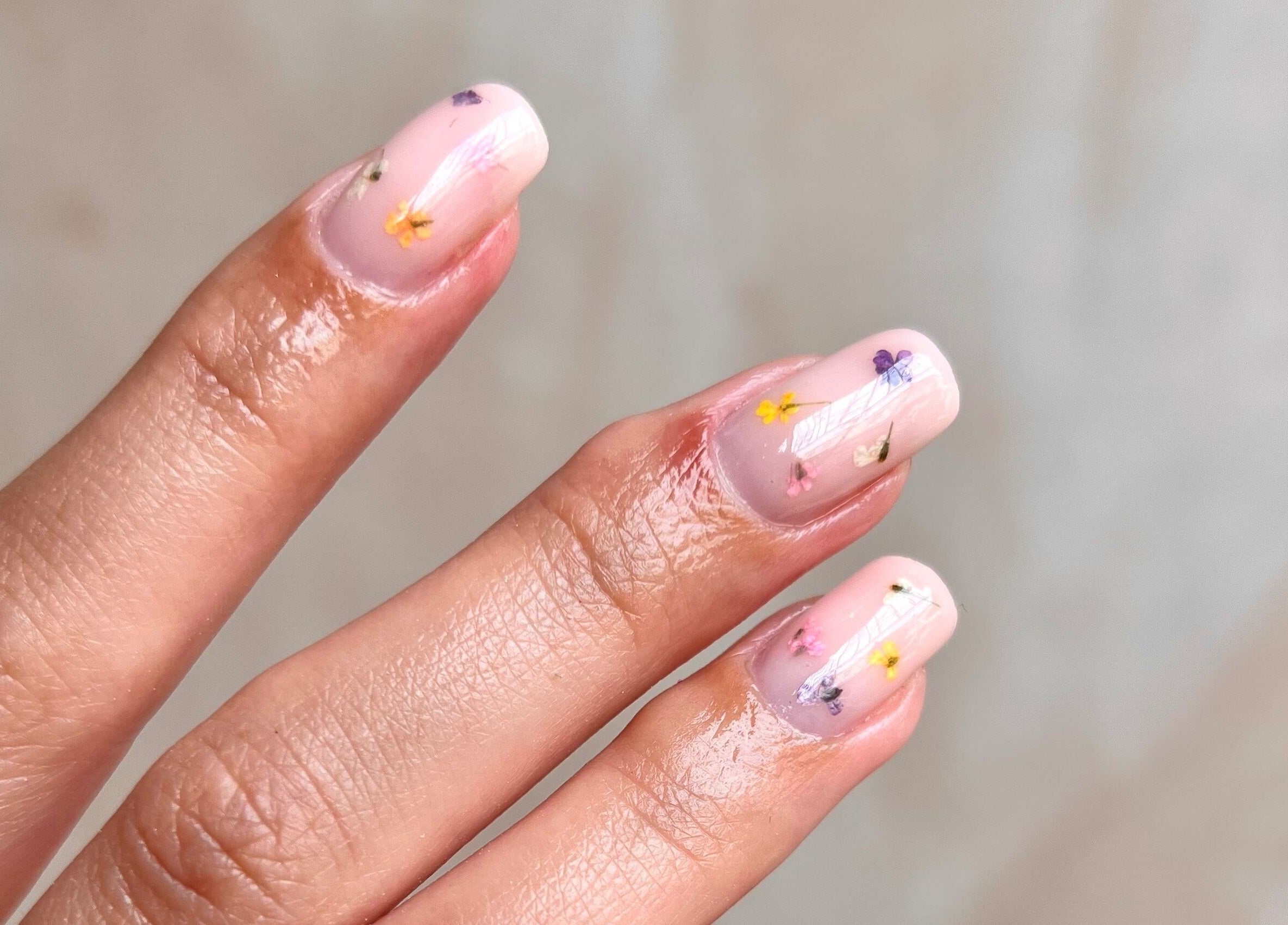 Floral nail art at Dia Nailed It, Hove, England, GB. Delicate designs on fresh manicured fingers.