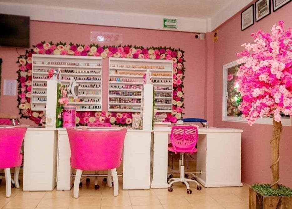 Mesa de uñas en Studio Fabiola Farias, Lázaro Cárdenas, Michoacán, MX con decoraciones rosadas exuberantes.