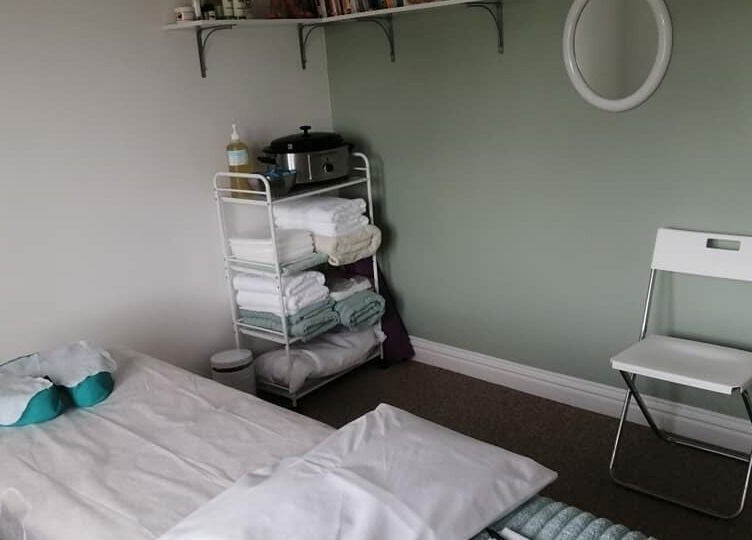 Peaceful therapy room at Allfit Holistics with massage bed, chair, and towels in Fareham, England, GB.