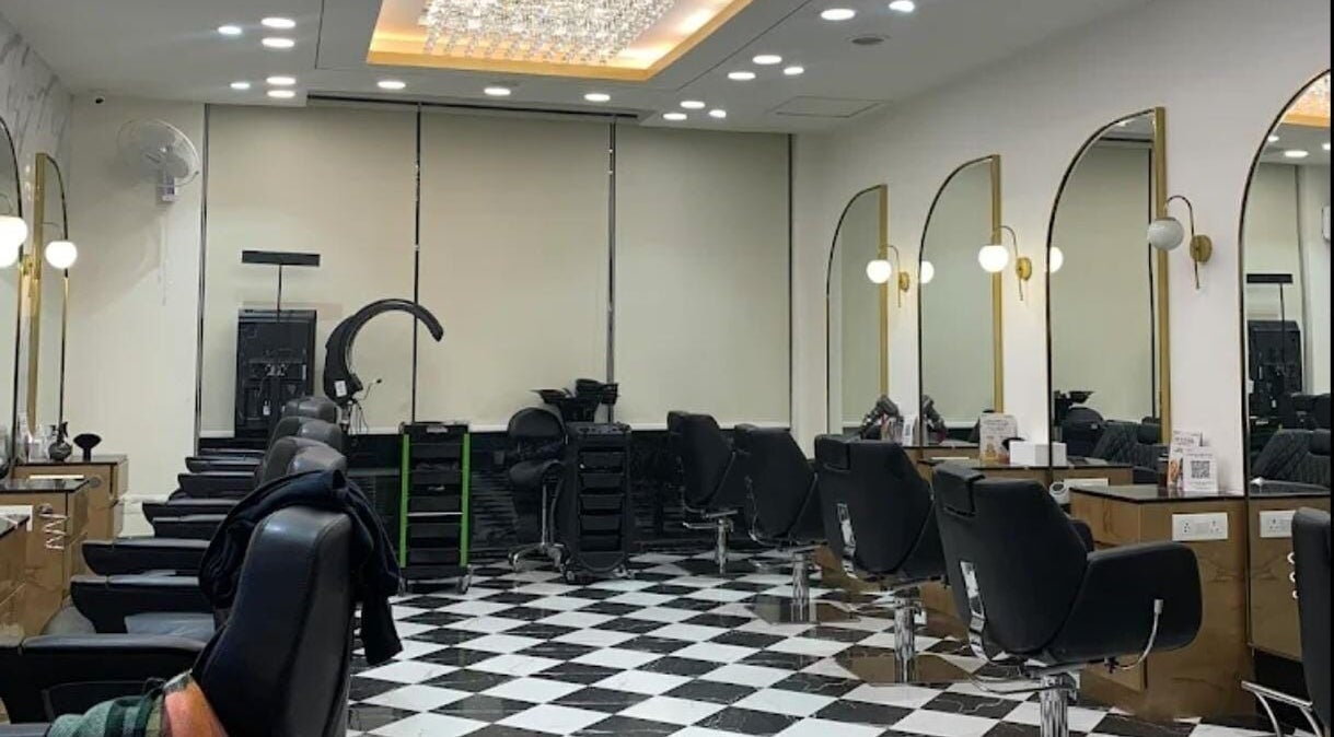 Modern salon interior at Curl Care @ Noida, featuring stylish black chairs and mirrors. Noida, Uttar Pradesh, IN.