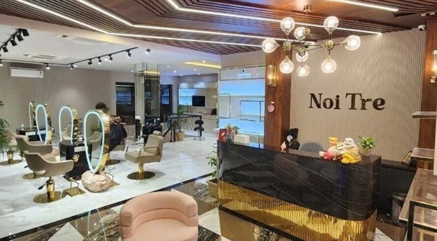 Sophisticated interior of Curl Care - Noi Tre Ashok Vihar in Delhi, showcasing chic salon stations and reception.