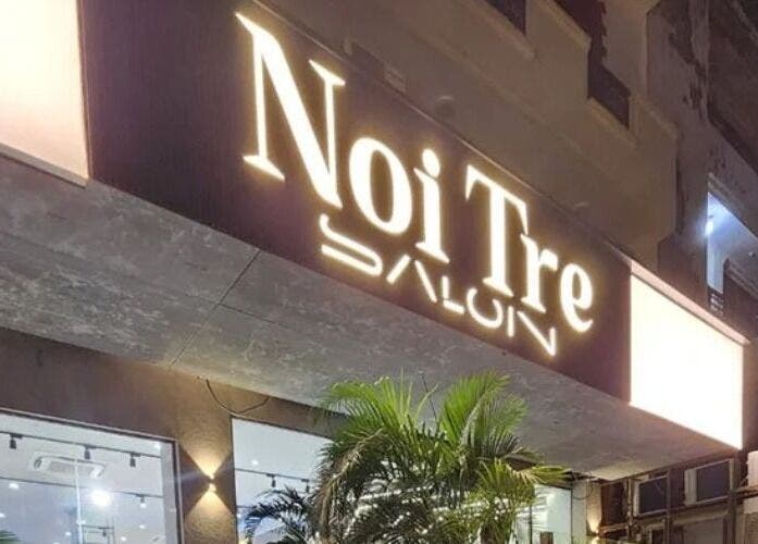 Exterior night view of Curl Care - Noi Tre Ashok Vihar, Delhi, Delhi, IN beautifully lit with vibrant signage.