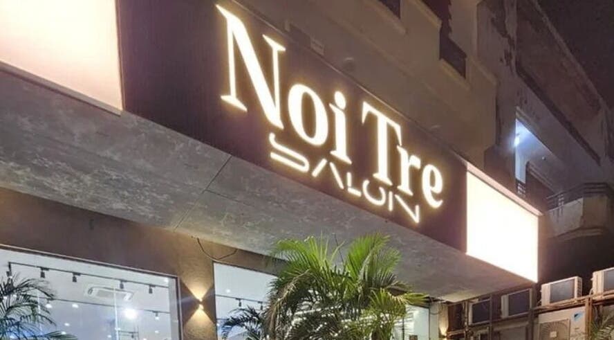 Exterior night view of Curl Care - Noi Tre Ashok Vihar, Delhi, Delhi, IN beautifully lit with vibrant signage.