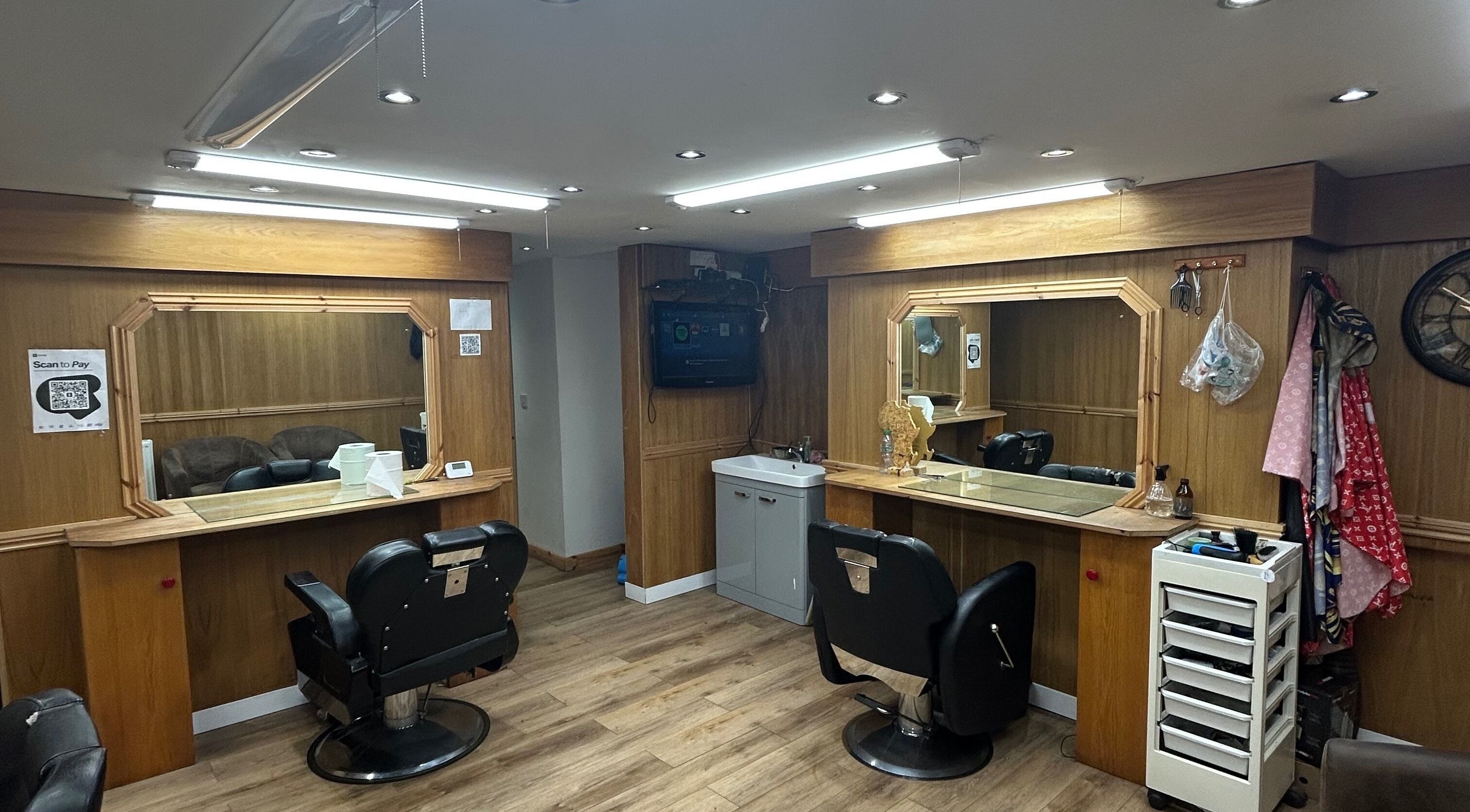 Modern styling station at Claude Nell Hair Academy Ltd, Rochdale, England, GB. Exquisite wooden decor and chairs.