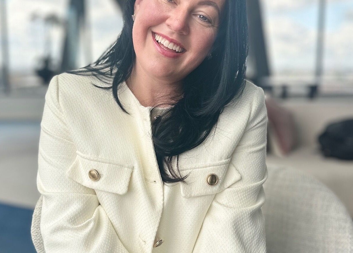 Smiling woman in elegant attire at LymphLondon by Bruna Milioli | Home Service, London, England, GB.