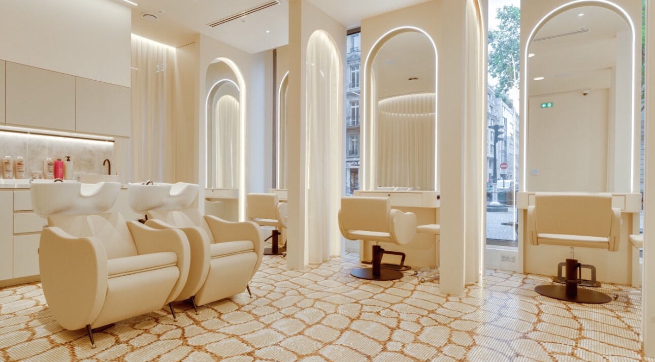 Elegant interior of Dmitrievski Hair Stylist in Paris, Île-de-France, FR showcasing modern chairs and wash stations.