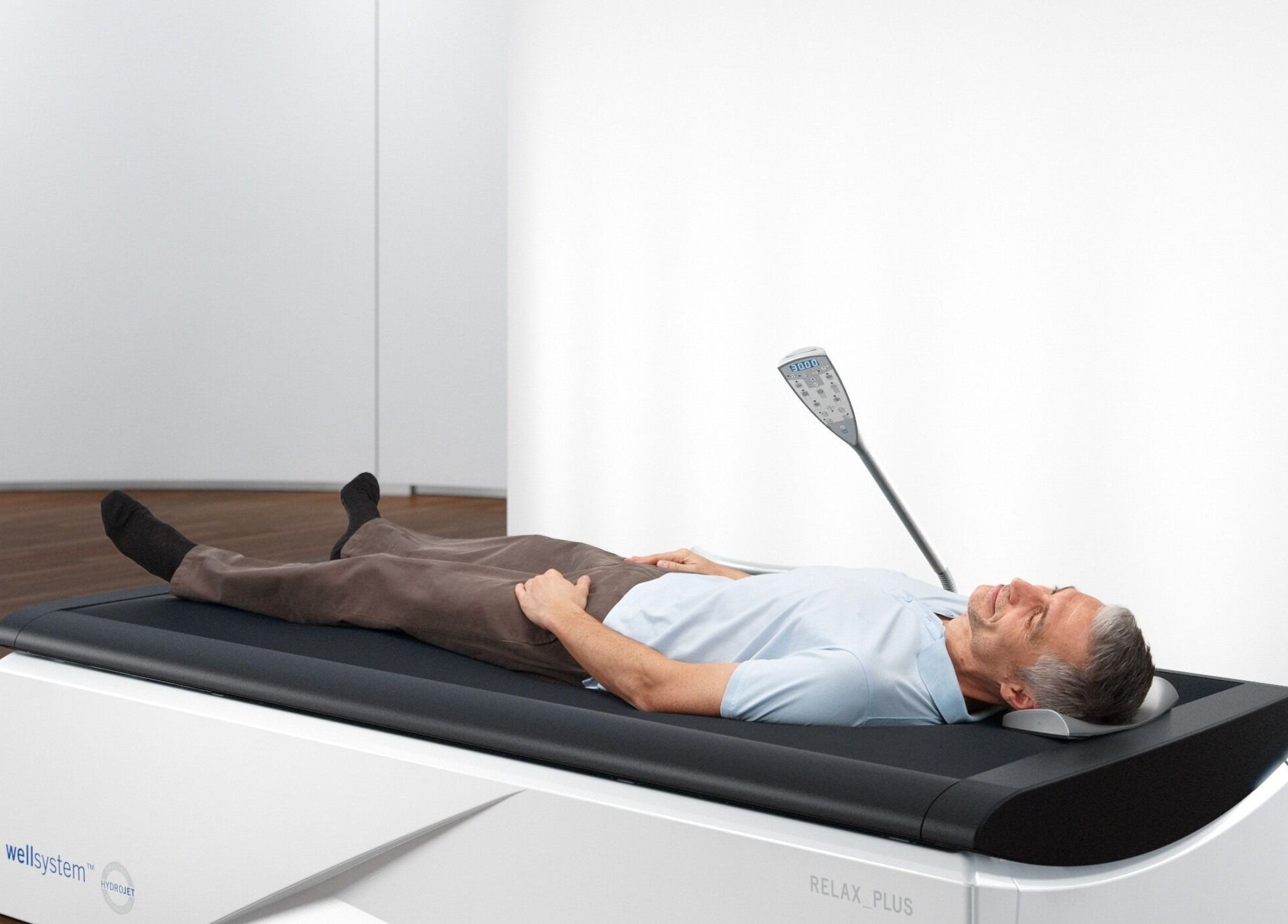 Man relaxing on hydromassage bed at GlowFit Wellness, Melbourne, Victoria, AU.