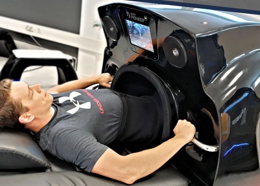 Man using a wellness pod at GlowFit Wellness in Melbourne, Victoria, AU, showcasing modern fitness technology.
