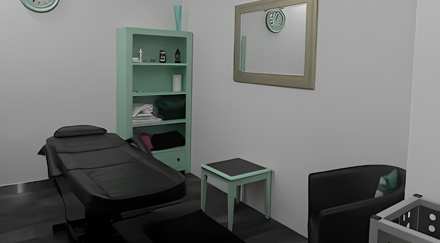 Elegant wellness room at Krasunya, Stirling, Scotland, GB showcasing a tranquil treatment space with black massage table.