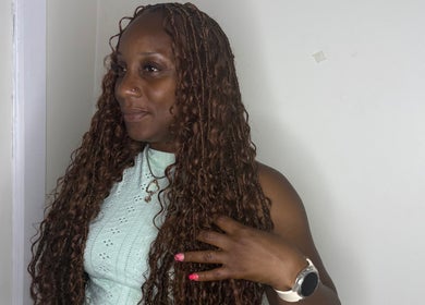 Woman in stylish curly hairstyle at GoldPosh Beauty Parlour, Bridgetown, Saint Michael, BB.