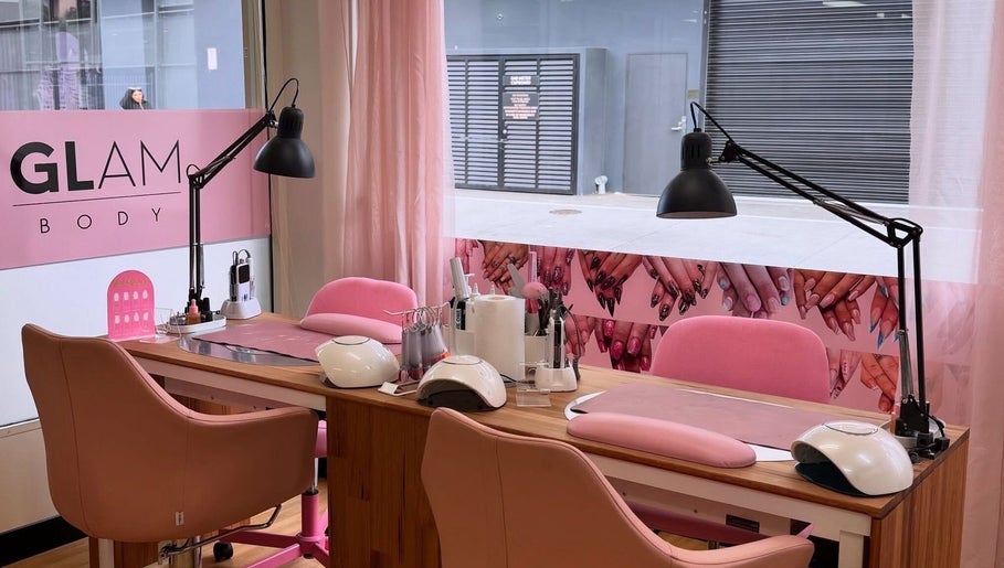Glam Body's stylish nail studio in Penrith, New South Wales, AU, featuring pink decor and manicure stations.