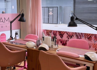 Glam Body's stylish nail studio in Penrith, New South Wales, AU, featuring pink decor and manicure stations.