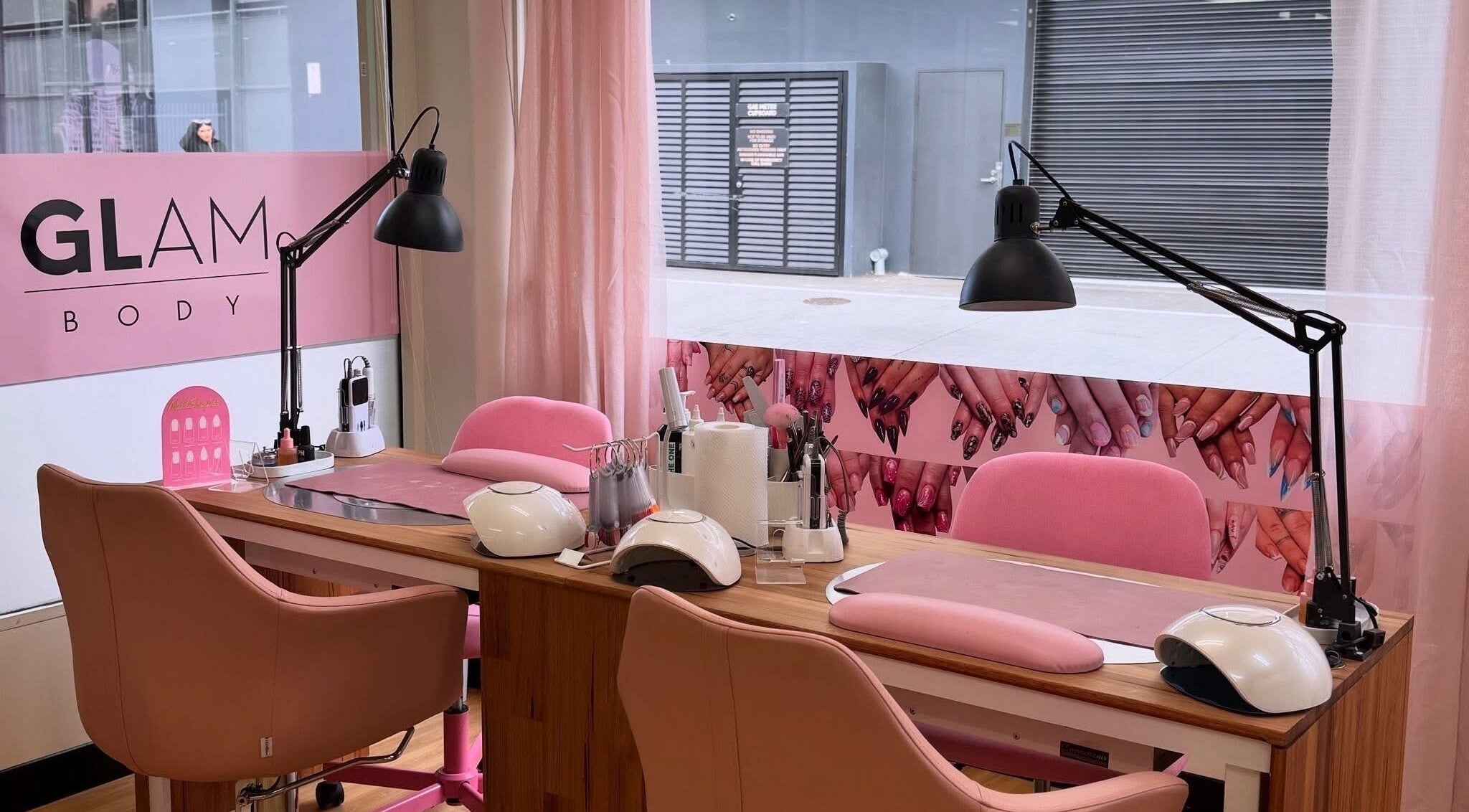 Nail salon workspace at Glam Body, Penrith, New South Wales, AU, with pink decor and nail tools.
