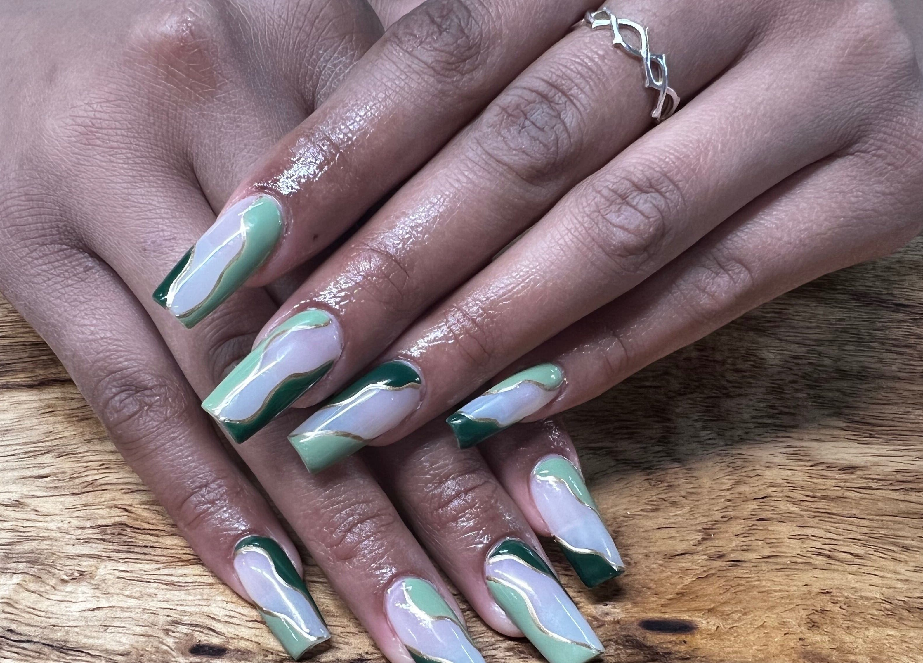 Stylish green wave nail art at Sweetie Skin and Nails in Greeley, Colorado, US.