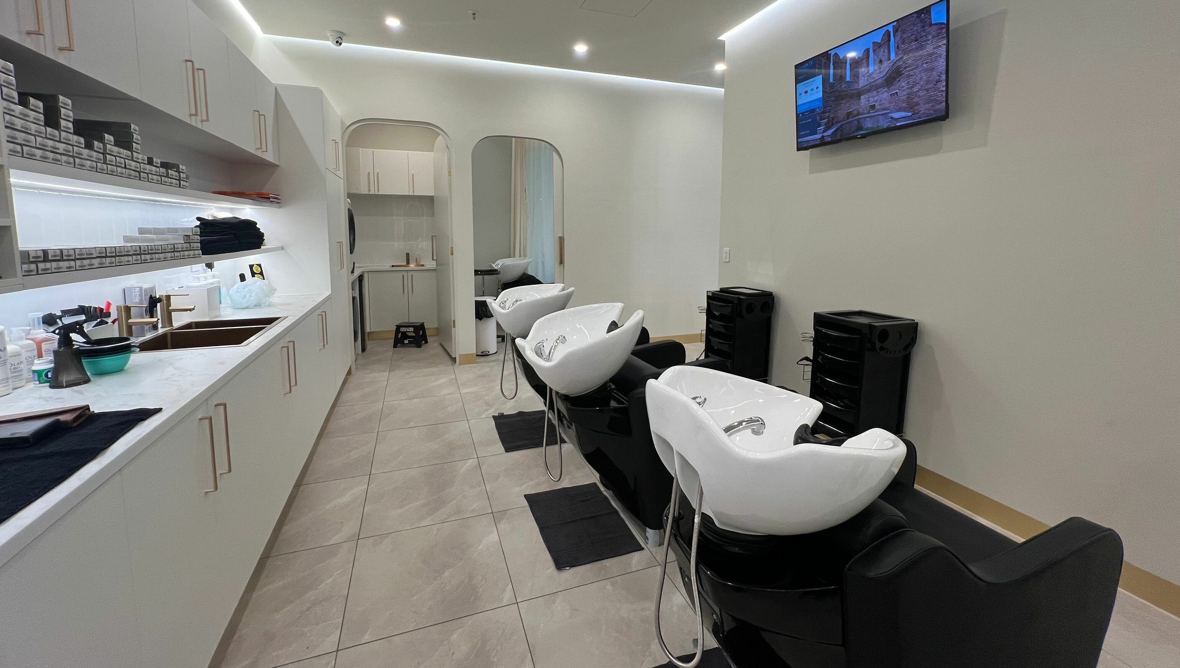 Modern hair washing stations at Marvin Salon in Fairfield, New South Wales, AU featuring sleek design and comfortable seating.