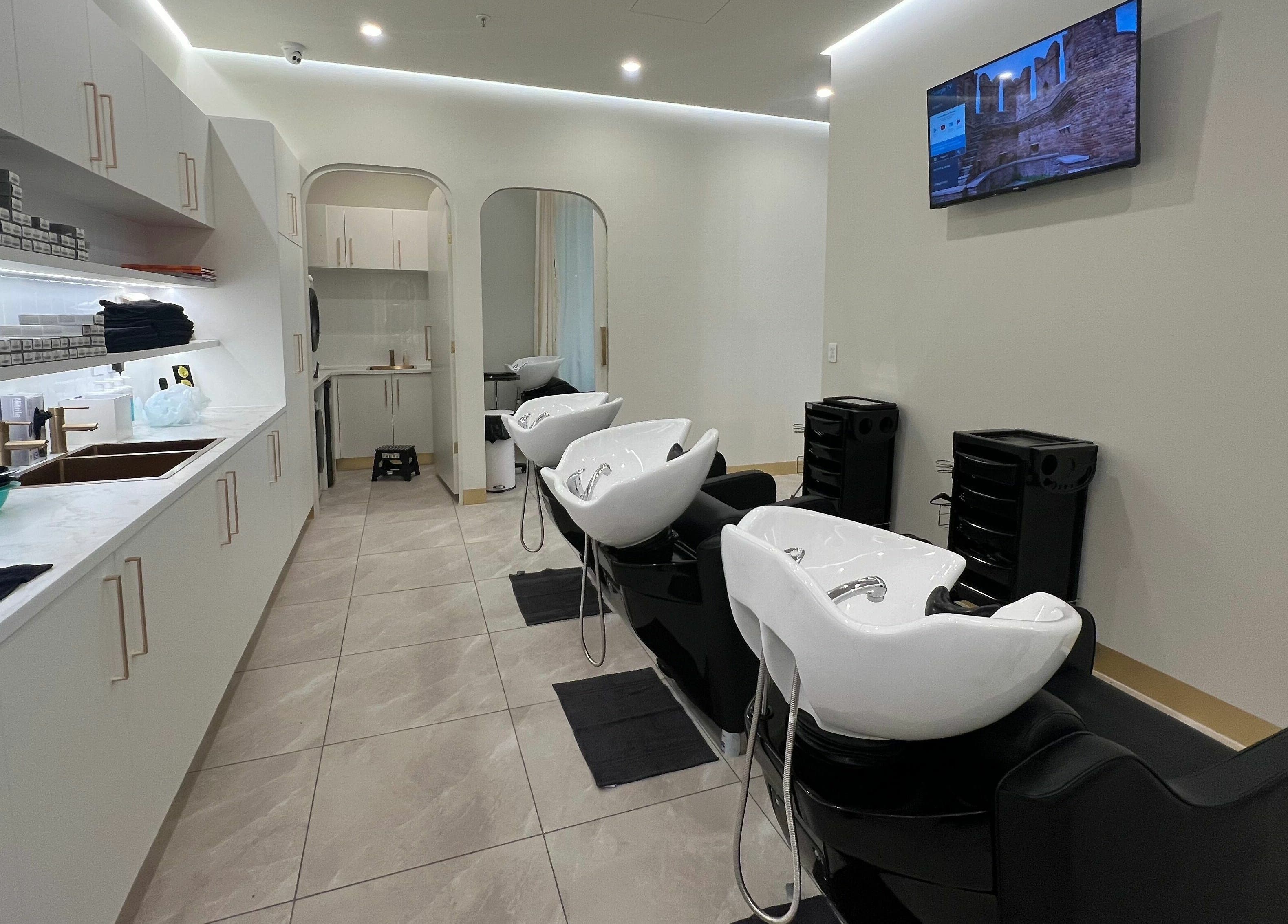 Modern hair washing stations at Marvin Salon in Fairfield, New South Wales, AU featuring sleek design and comfortable seating.