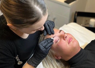 Technician shaping brows at Zena Beauty, Nouvelles Hair & Beauty, Epsom, England, GB for flawless skin care.