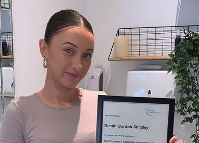 Staff holding a certificate at Zena Beauty at Nouvelles Hair & Beauty in Epsom, England, GB.