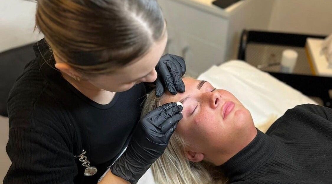 A beautician shapes eyebrows at Zena Beauty at Nouvelles Hair & Beauty, Epsom, England, GB.
