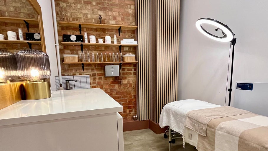 Relaxing treatment room at Facials by MS in Sutton, England, GB, featuring cozy bed and ambient lighting.